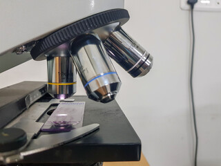 close up view of a light microscope with glass slide focussed