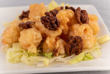 Detail view of appetizing plate tempting the tastebuds with Honey Walnut Shrimp in perfect serving size.