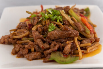 Detail view of appetizing plate tempting the tastebuds with Pork Szechuan style in perfect serving size.