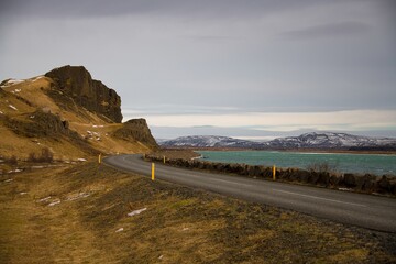 Roadway in Iceland with mountains and a turquoise colored lake