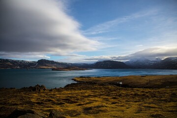 Ocean water surrounded by mountains on the western coast of Iceland