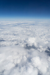 Vertical landscape over the clouds from airplane