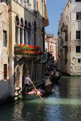 Fototapeta na wymiar Traffic jam of gondolas on a narrow canal in Venice
