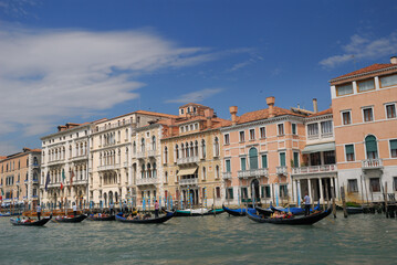 Fototapeta na wymiar Row of gondoliers plying the Grand Canal in Venice