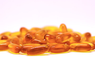 Cod liver oil omega 3 vitamin e gel capsules isolated on white background