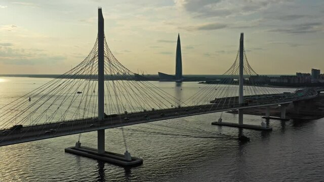 Aerial view of cable-stayed bridge and new skyscraper in St.Petersburg during sunset, 4k