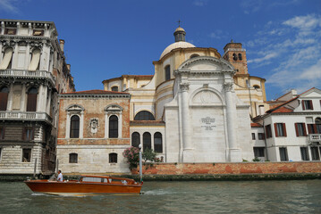 Fototapeta na wymiar Motorboat on Grand Canal at San Geremia church Venice