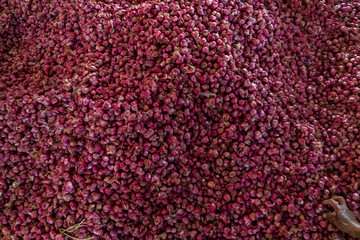 Red onions as seen in traditional market. Red onions are cultivars of the onion (Allium cepa) with purplish-red skin and white flesh tinged with red.