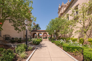 Balboa Park outdoor corridor between buildings and garden.