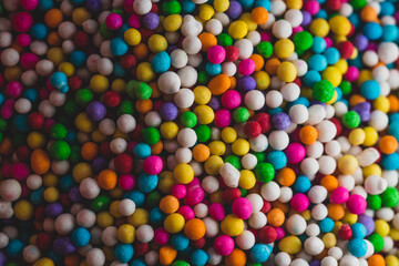 Fototapeta na wymiar Macro close up portrait of colorful candy sprinkles , studio lighting, selective focus