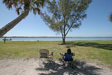 Young girl enjoying tent camping environment n Fort De Soto Park in Pinellas County, Florida.