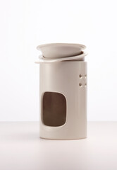 Clean plates, serving dishes and cups isolated on white