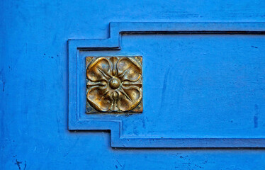 Golden decorative ornament on blue metallic gate, Belo Horizonte, Brazil 