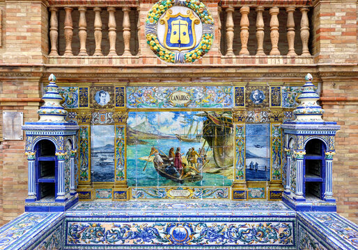 Image with the name of the Canary Islands and a historical scene painted on ceramic tiles - seating benches in Spain Square in Seville