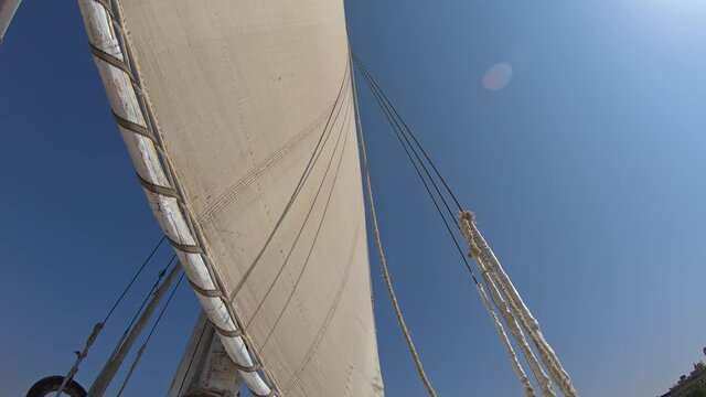 View from below on white sail of felucca boat in Egypt, 4k