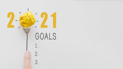 2021 Yellow paper light bulb, New year resolution and goal checklist