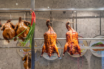 Naklejka premium Two Delicious Homemade Roasted ducks hung in kitchen