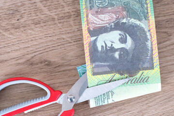 Scissors and cut Australian dollar banknotes