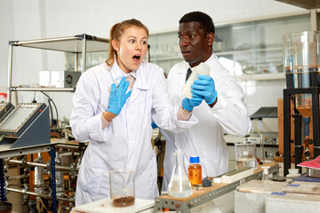 Worriend and scared male and female scientists after chemical experiment