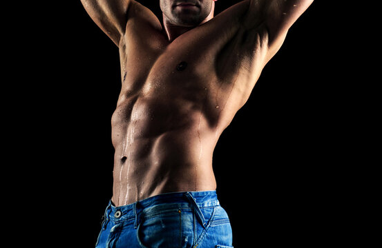 Mans torso. Sexy and naked muscular young man posing on the studio.