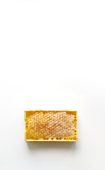 Fresh honey in a mini frame stands on a white background. Reserve vitamins for the winter. Lens soft focus