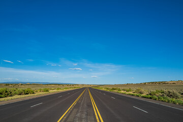 Fototapeta na wymiar Road panorama on sunny summer day. Highway on travel vacation.