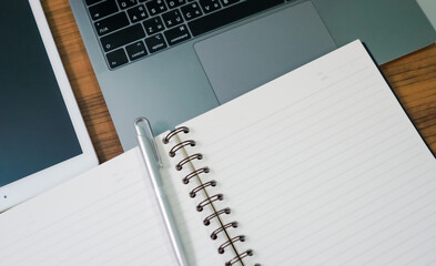 Notebook laptop and tablet on the wood table