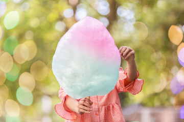 Woman with colorful cotton candy outdoors