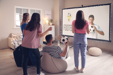 Young friends watching sports at home