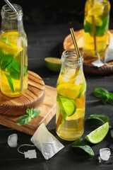Bottles of fresh ice tea on dark background