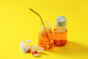 Bottles of fresh ice tea on color background