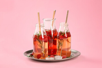 Bottles of fresh ice tea on color background