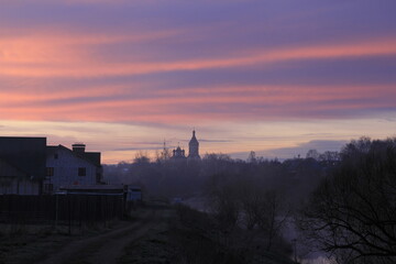 Landscape with the church silhouette in an early morning in April