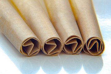 Close up of four Pre-rolls cannabis papers with filters Tips or Roach Papers.