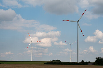 Fototapeta premium a group of wind turbines in rural landscape