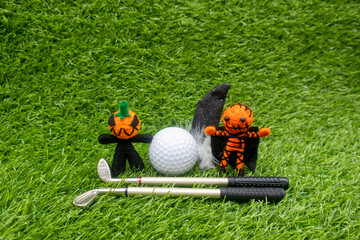 Happy Halloween to golfer with golf ball and ghost on green grass