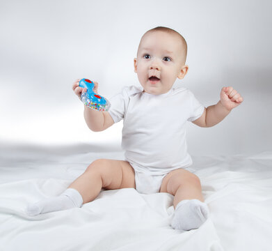 Photo Of A Ten-month-old Baby Boy Holding Blue Rattle