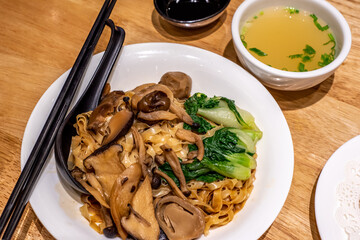 Dry noodles with assorted mushrooms served with soup