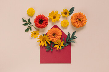 Creative composition of flower buds in red envelope. Top view, flat lay, holiday background concept.