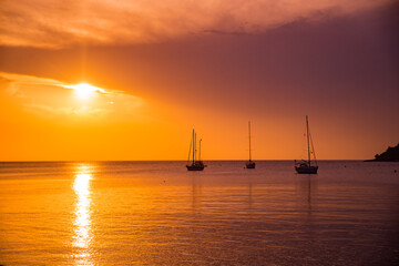 Fototapeta na wymiar sunset over sea bay with yachts on background