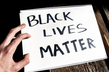 a white man's hand is located on a banner with the inscription 