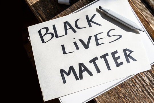 creating "black lives matter"  banner. poster with inscription "black lives matter" and marker. preparing activists for protests and demonstrations against racism and police brutality.