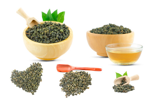 Dry green oolong tea in wooden bowl an isolated on white background with clipping path