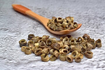 green jasmine tea on a wooden spoon