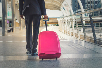 Businessman and suitcase in the airport departure lounge , traveler suitcases in airport terminal,Travel concept.