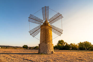 Naklejka na ściany i meble Old restored stone windmill in countryside in Majorca island, Spain. Historic buildings