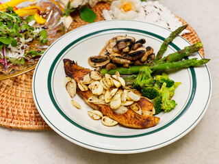 Delicious fillets of pollock or coalfish cooked in a spicy marinade served with garlic and Asparagus as a seafood appetizer to dinner