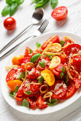 tomato salad with fried onion, quinoa and basil