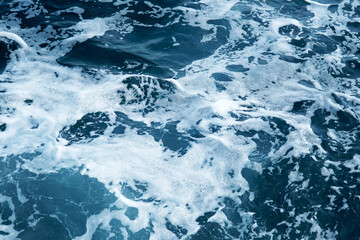       Kind of seawater with waves and foam.