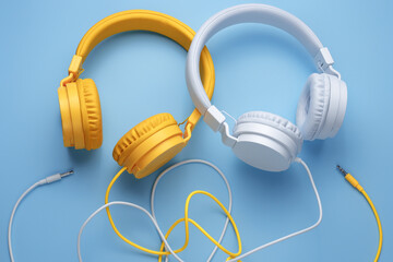 Two stylish headphones over blue background. Music concept.